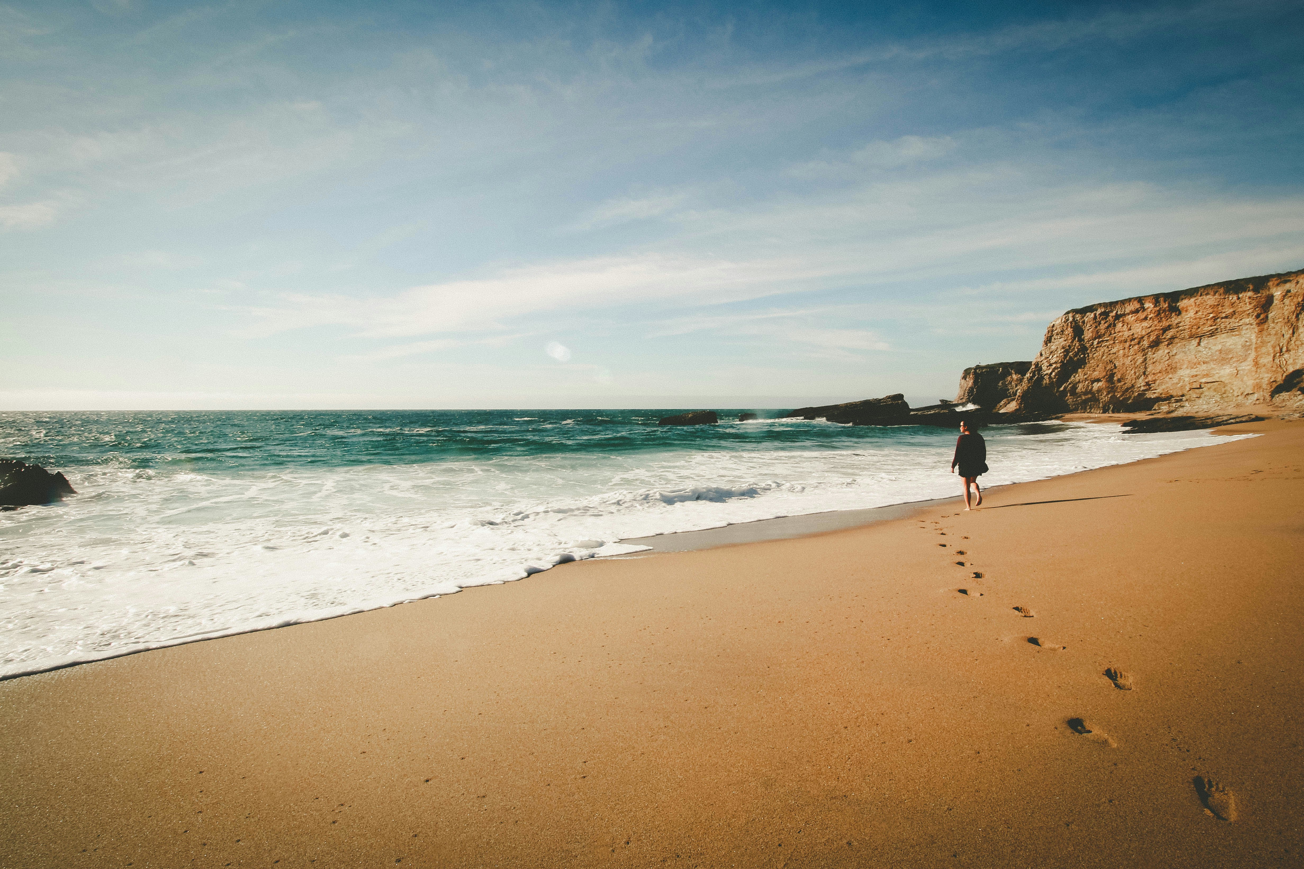 A woman walking along a beach