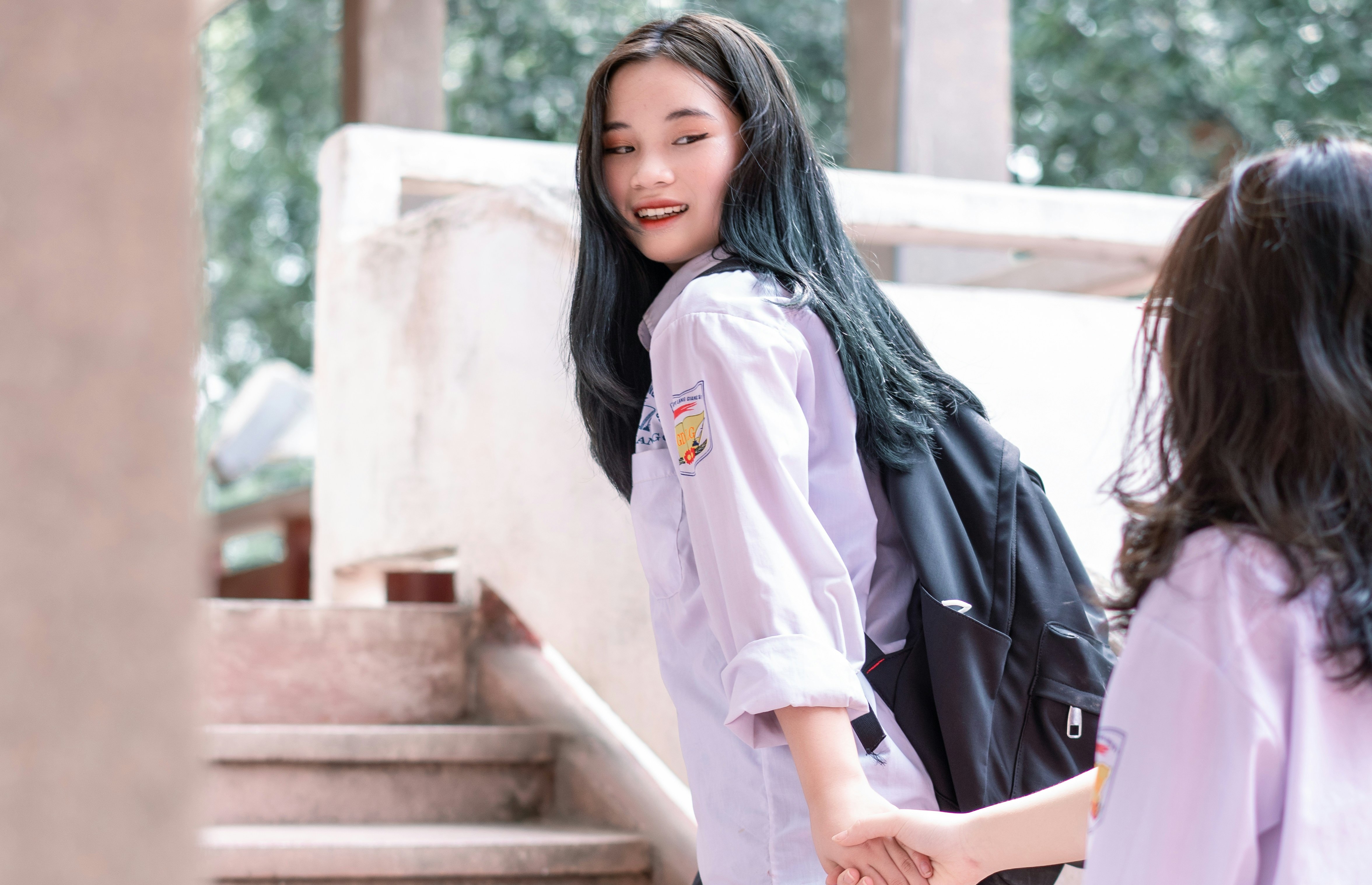 two sisters walking up the stairs together at school