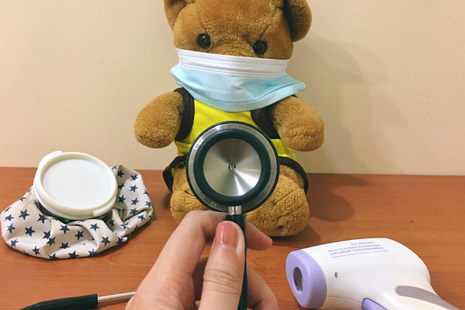 A teddy bear getting a medical exam