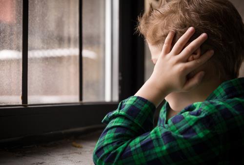 child covering his ears