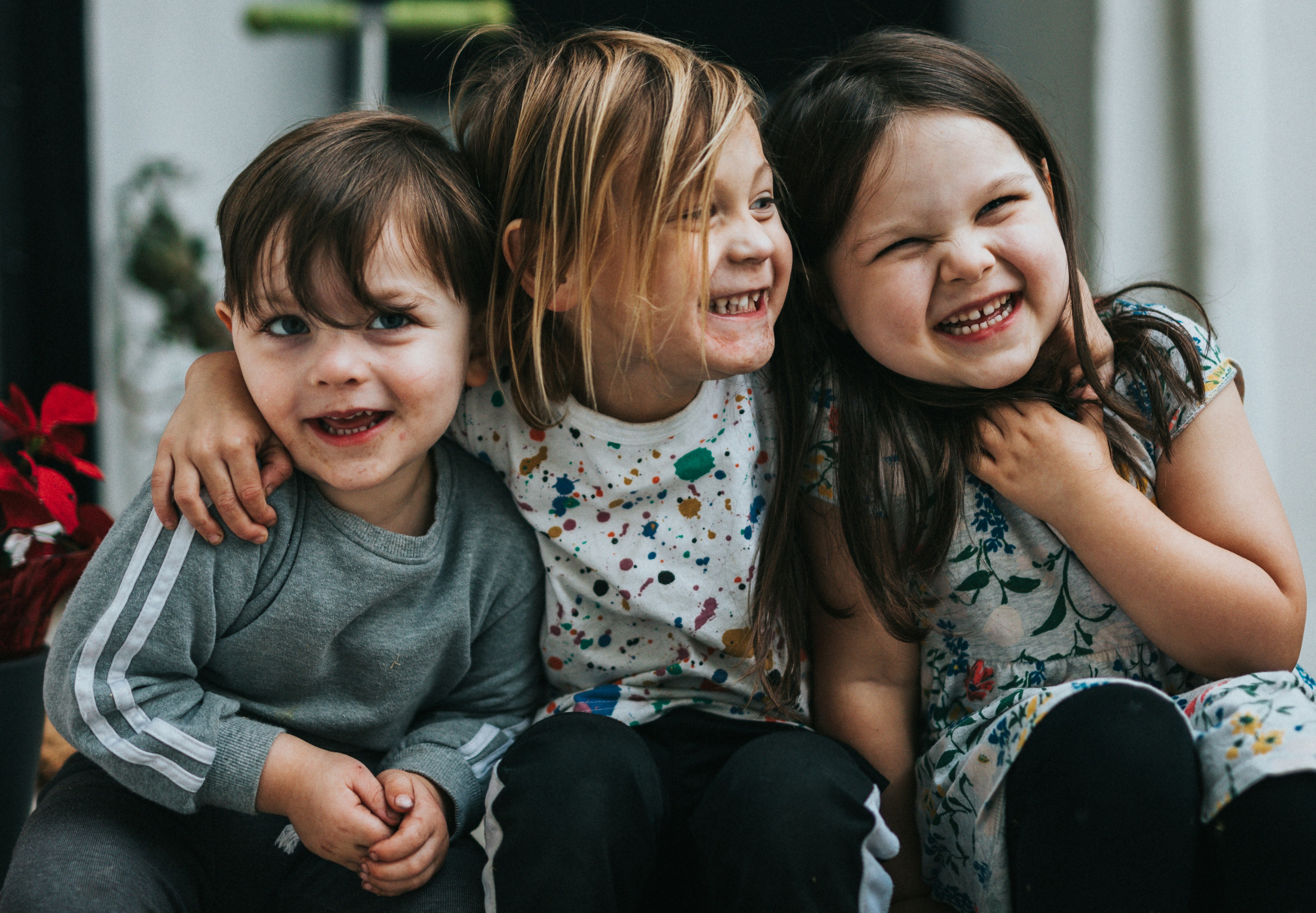 three children laughing together