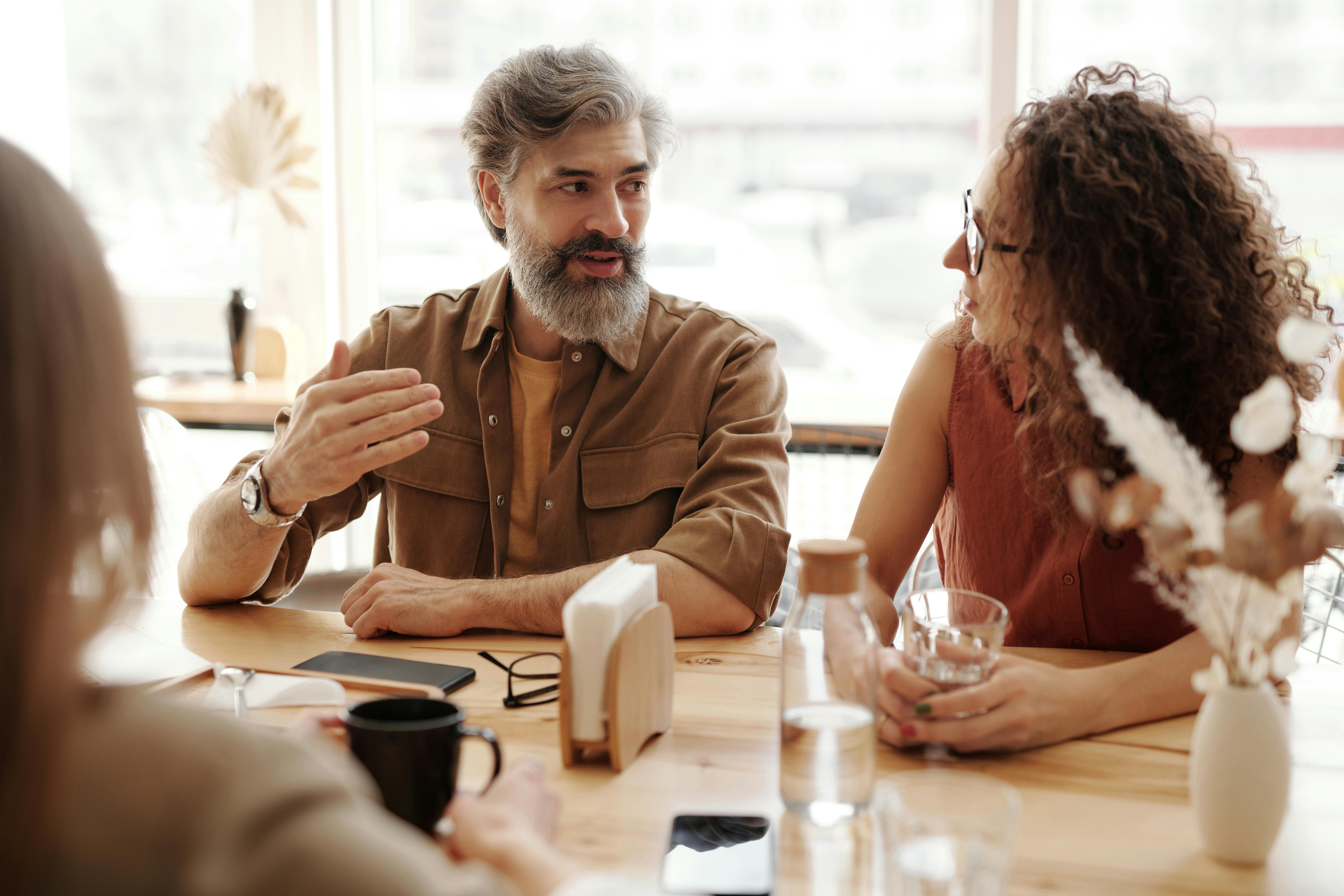 A group of people talking at a table