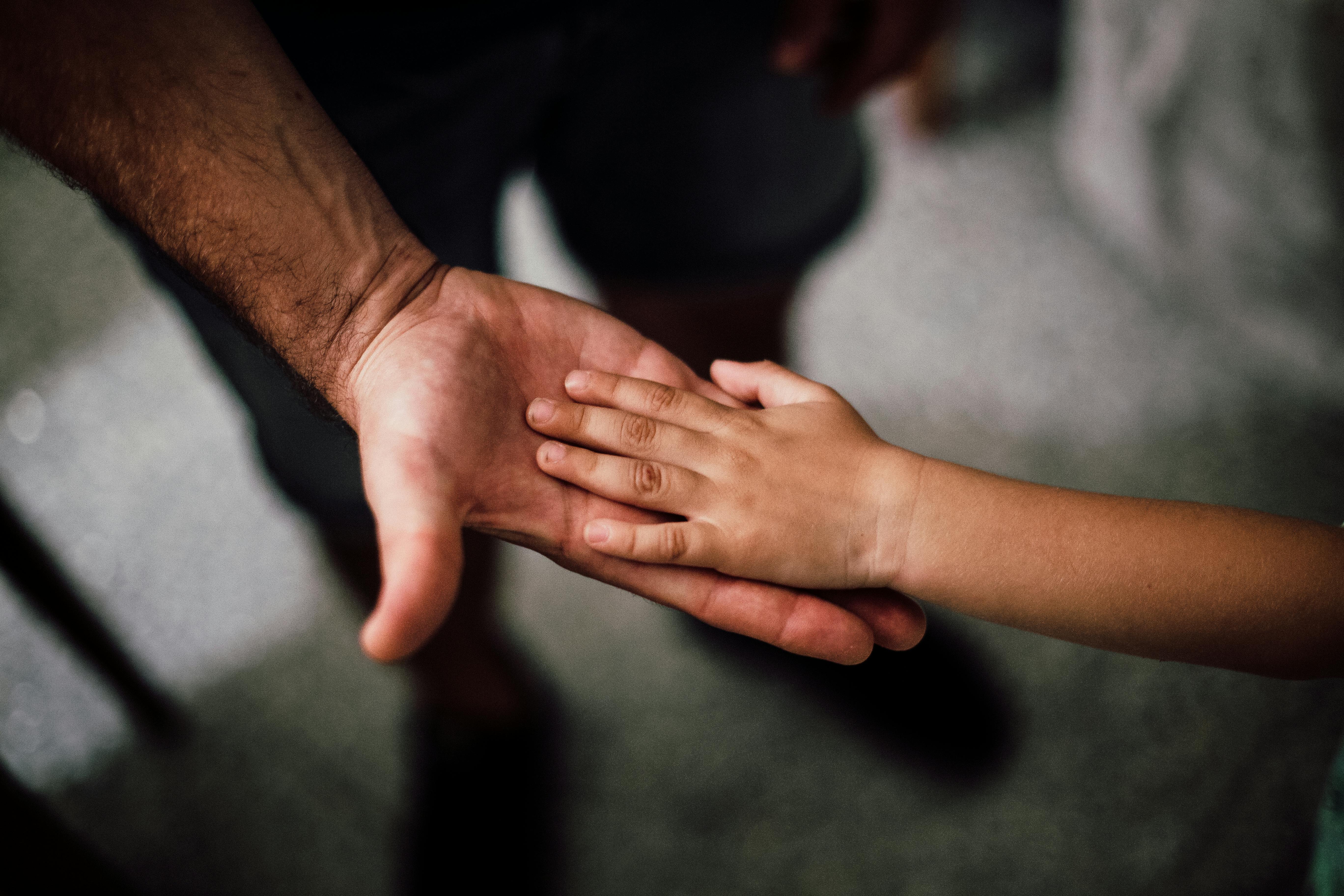A Father’s and Child's Hands Together