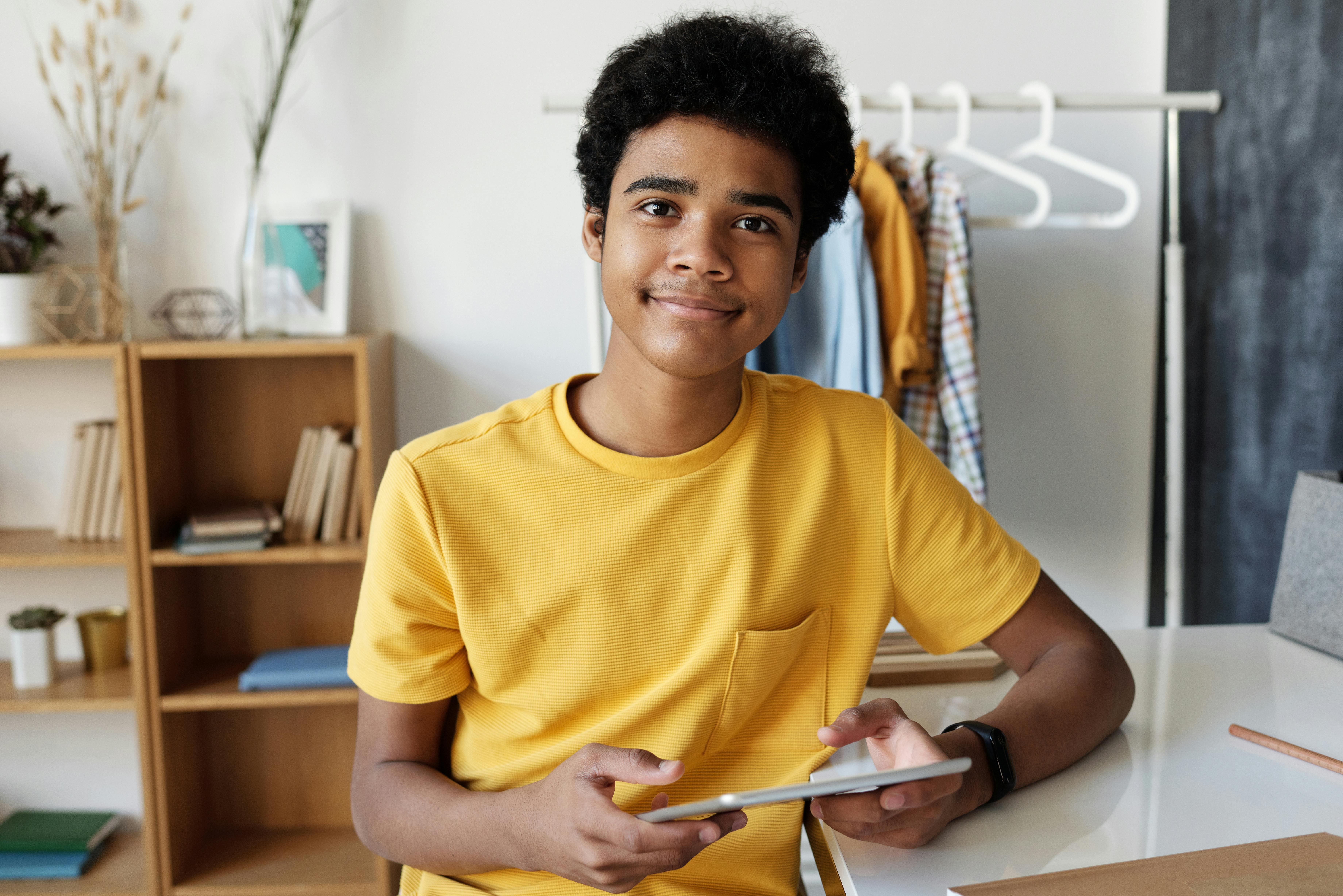 Boy in a Yellow T-shirt Holding a Tablet