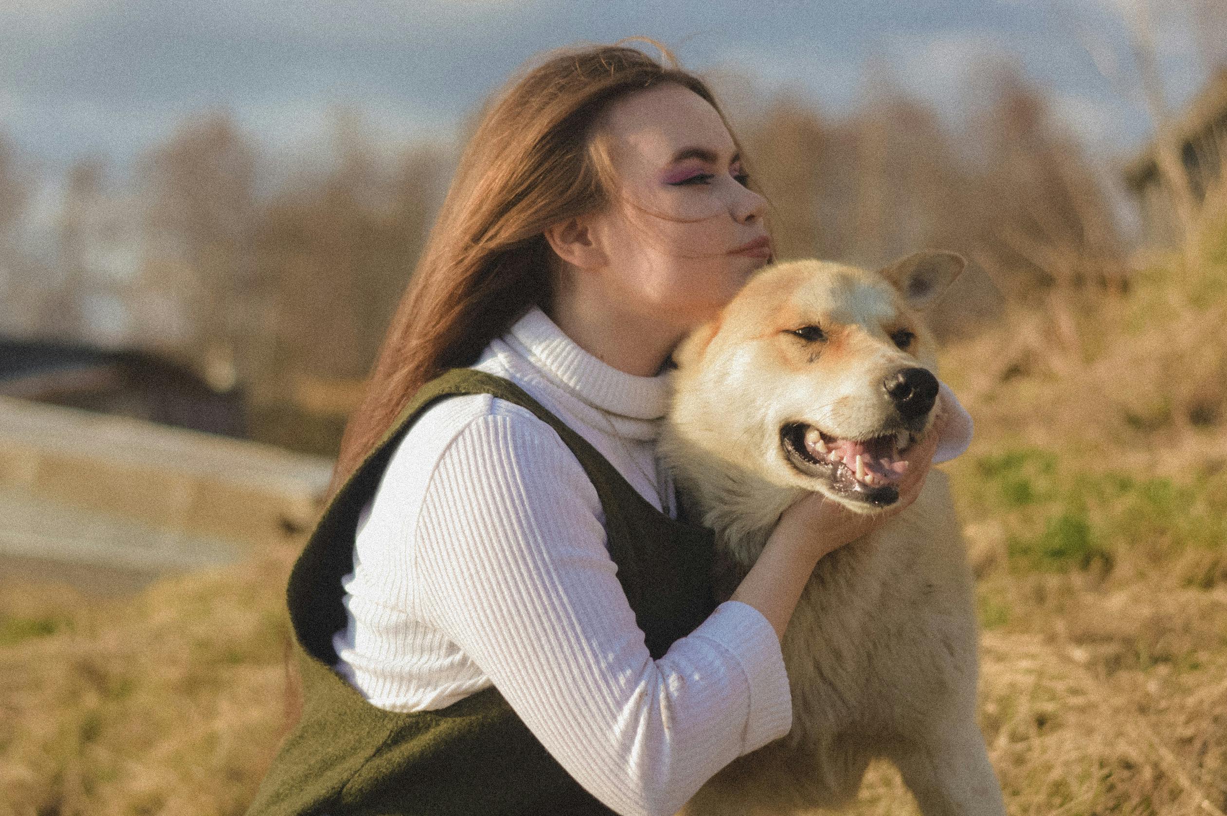 A woman sitting outside with her dog