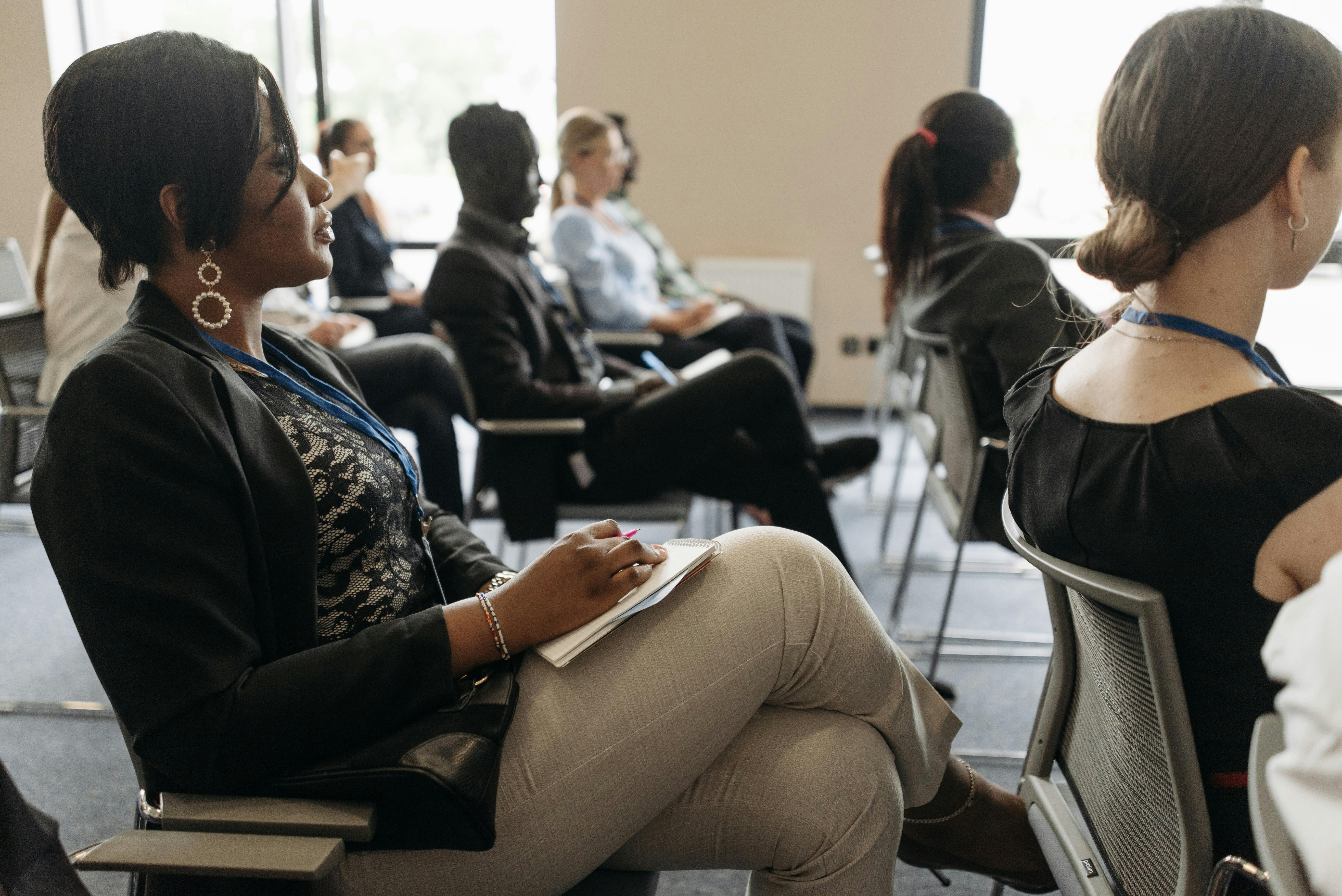 Audience members watching a presentation at a conference