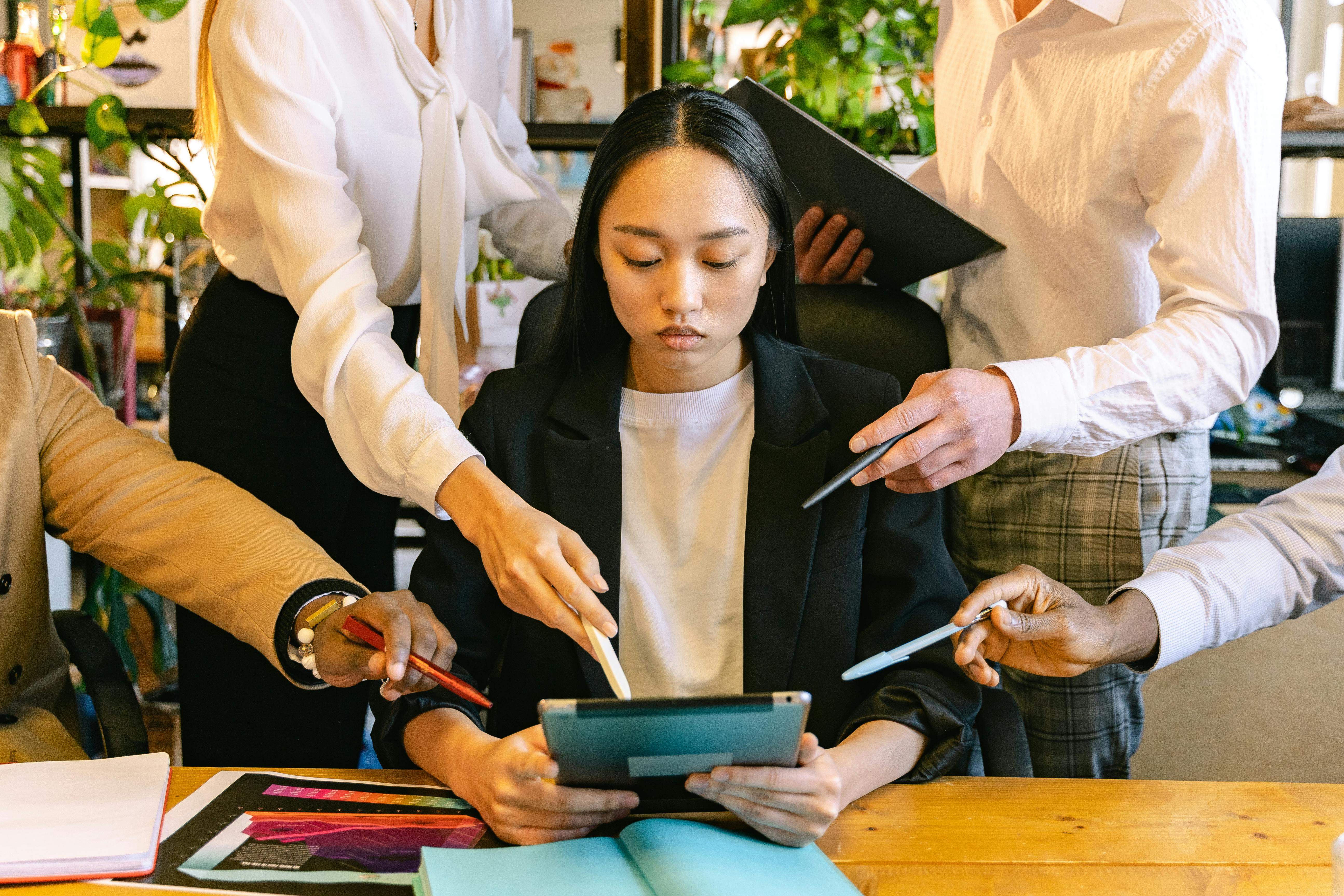 A woman getting conflicting instructions from multiple people at once