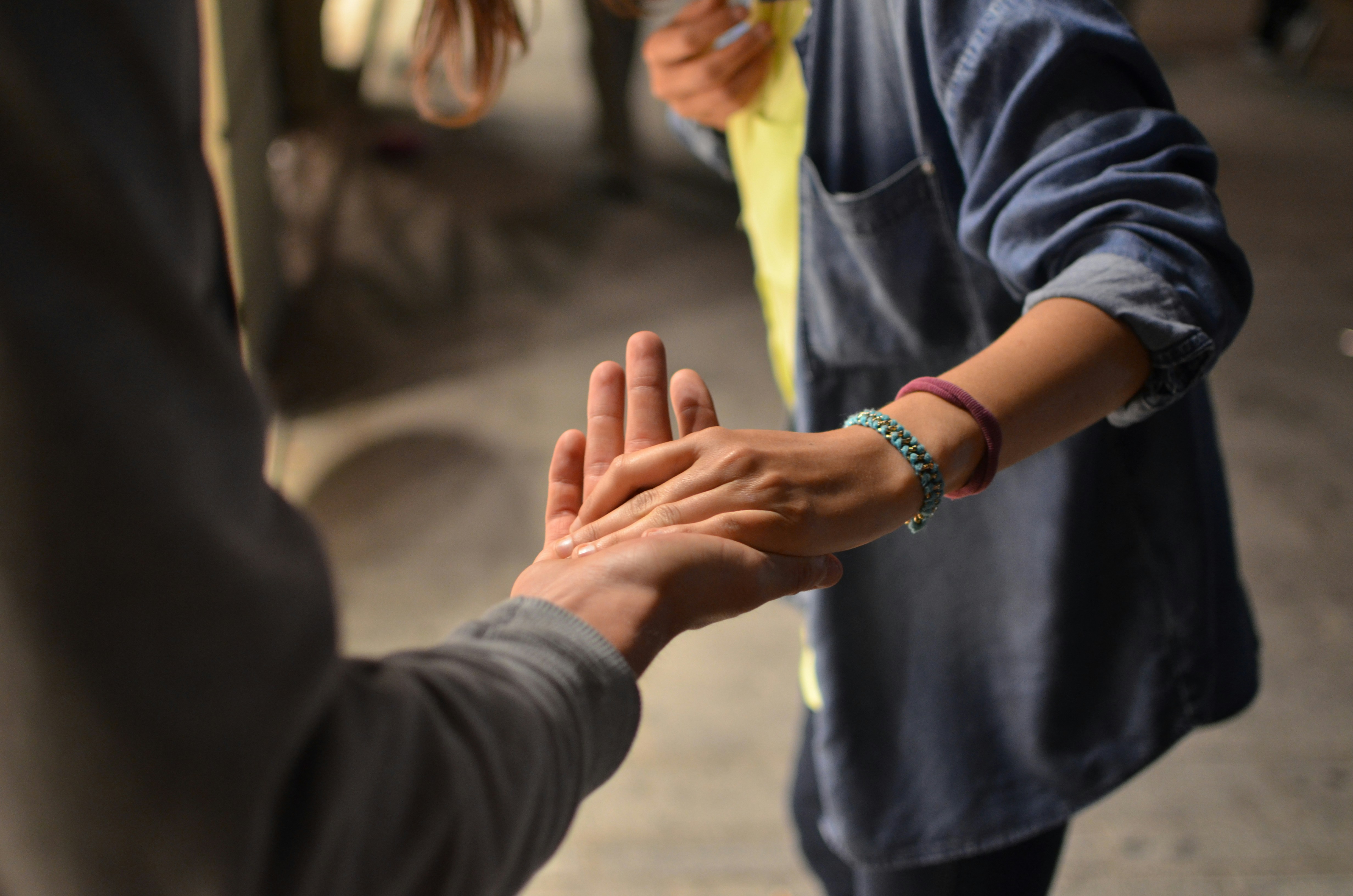 Two people holding handing in support