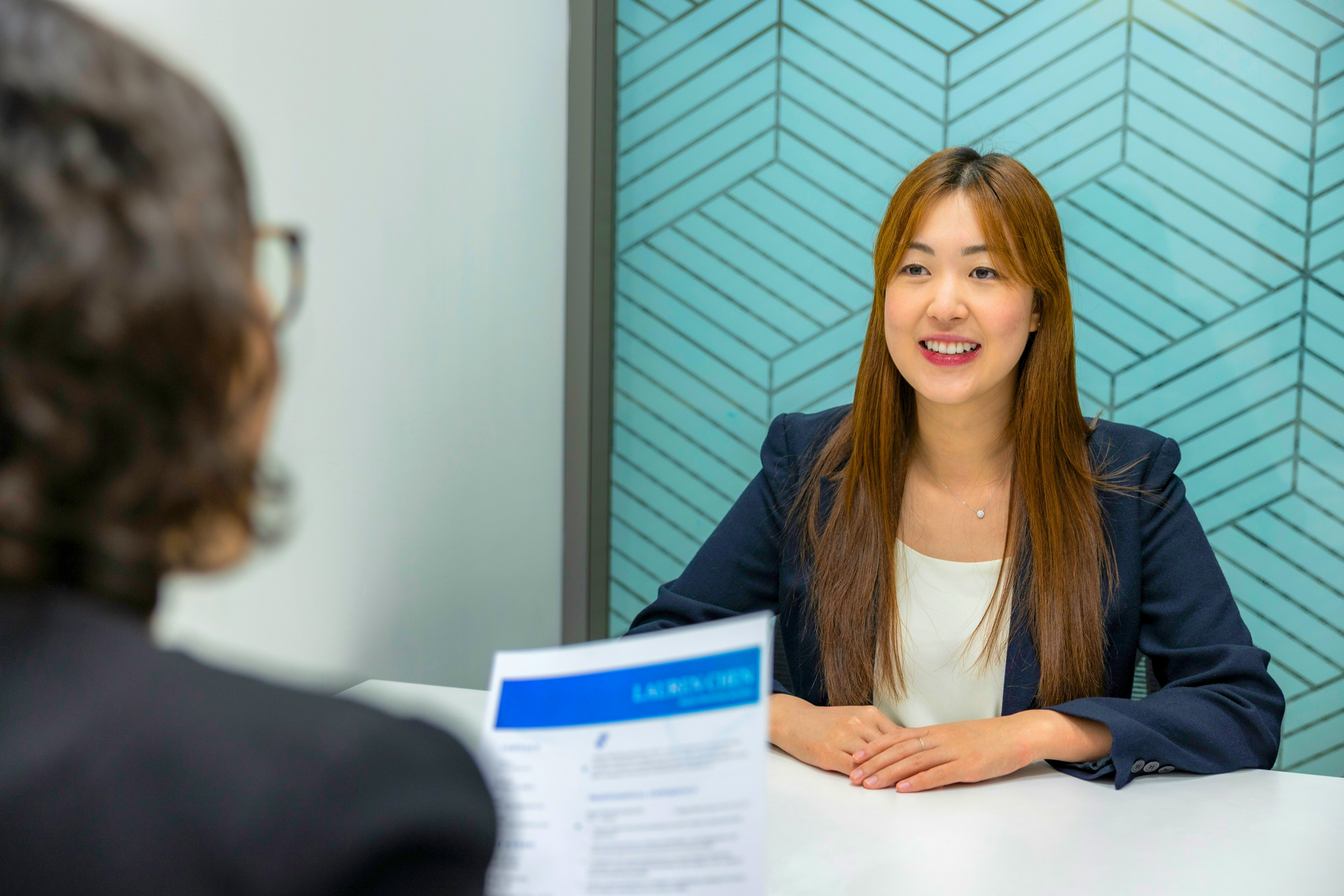 A woman having her resume reviewed at a job interview