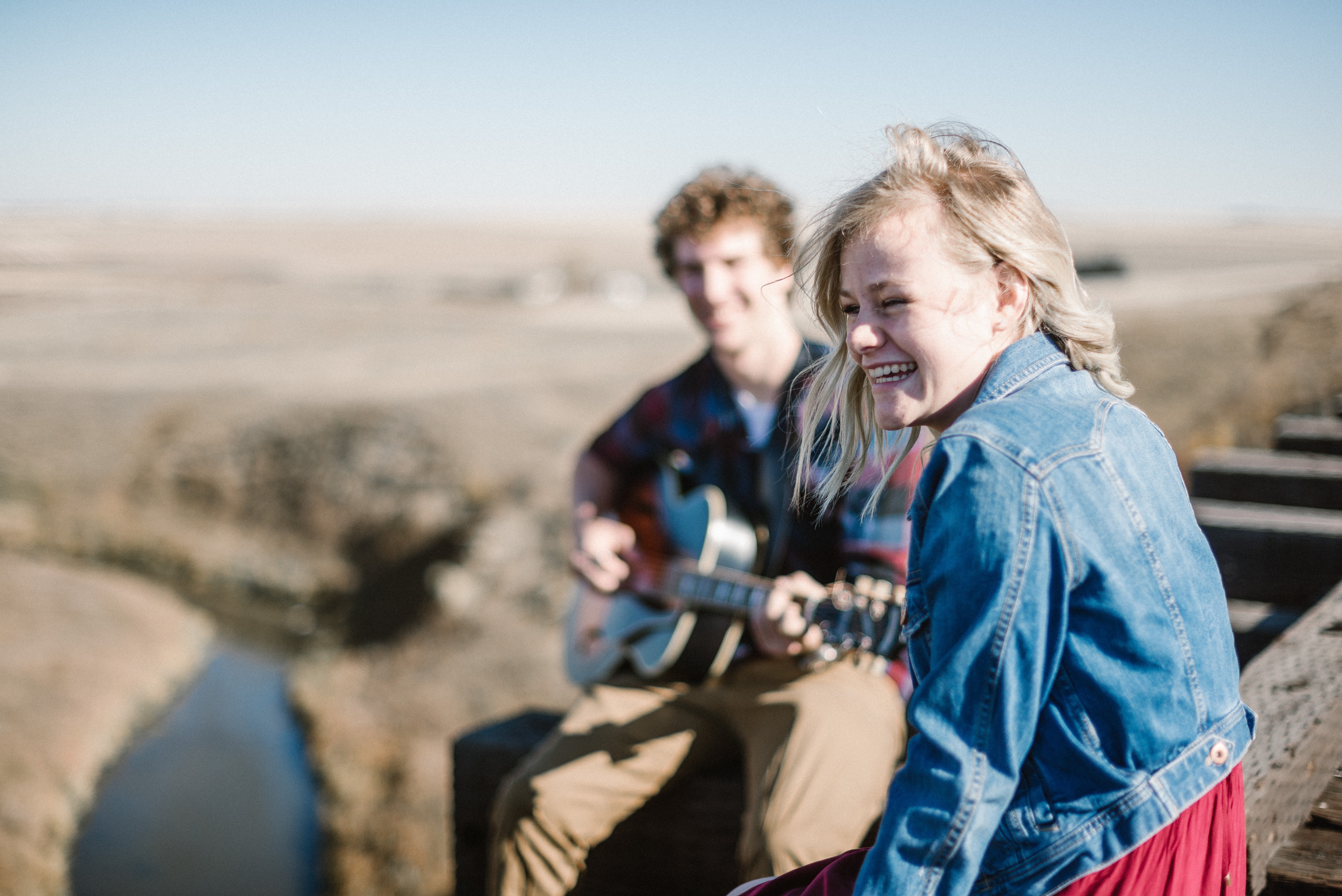 Friends playing guitar outdoors