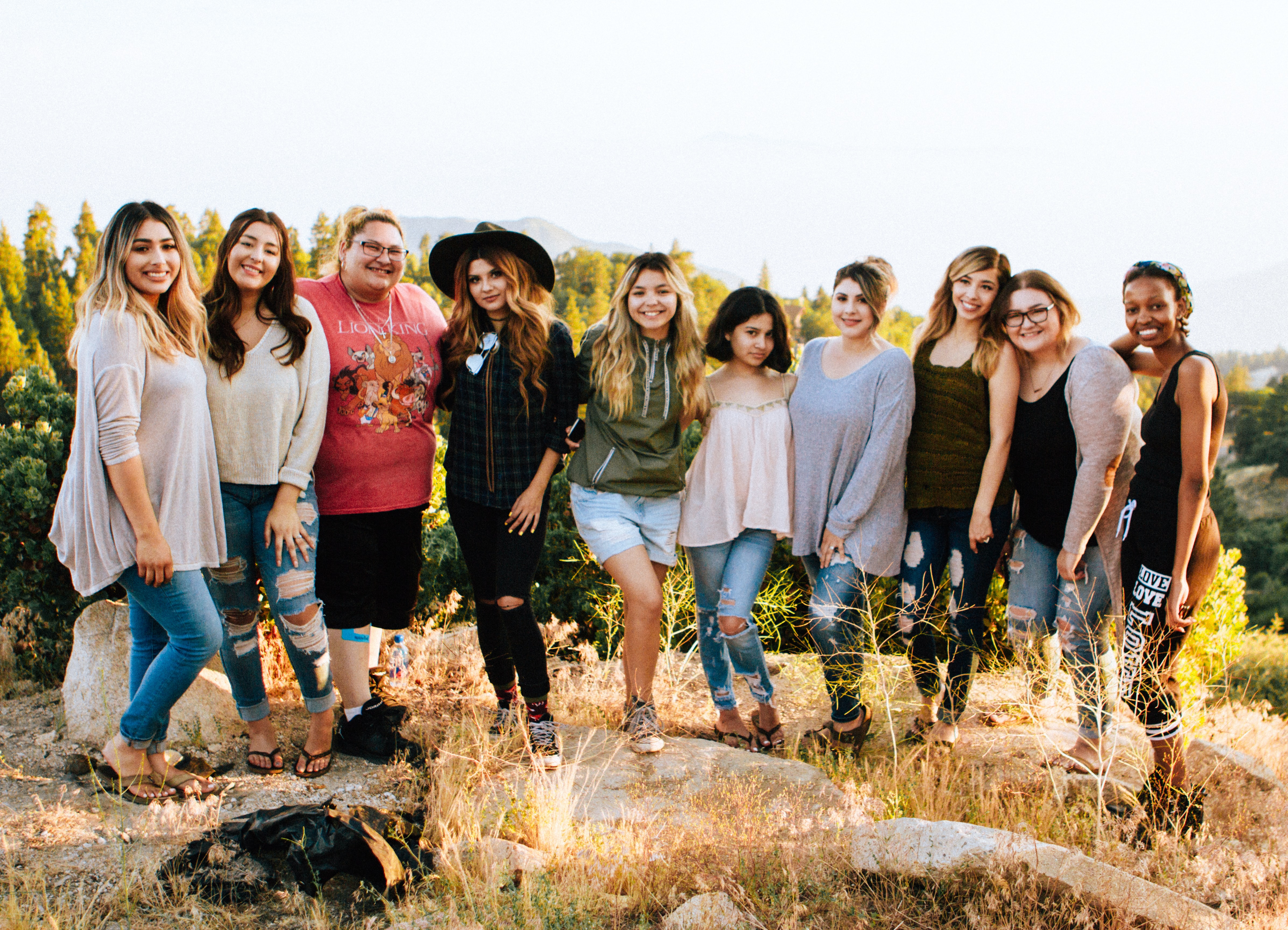 10 people standing in a row smiling
