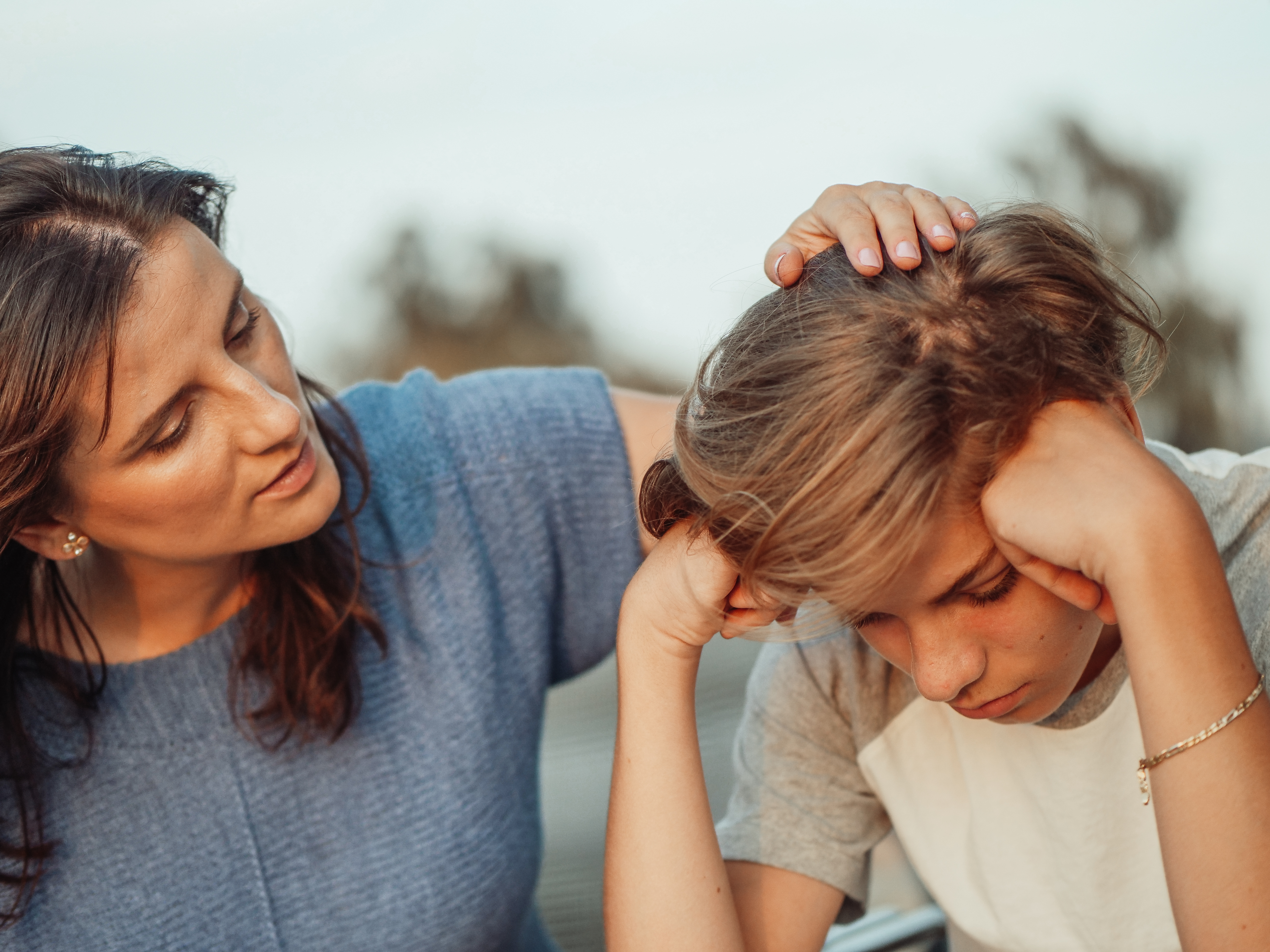 Mother talking to teenager who looks sad