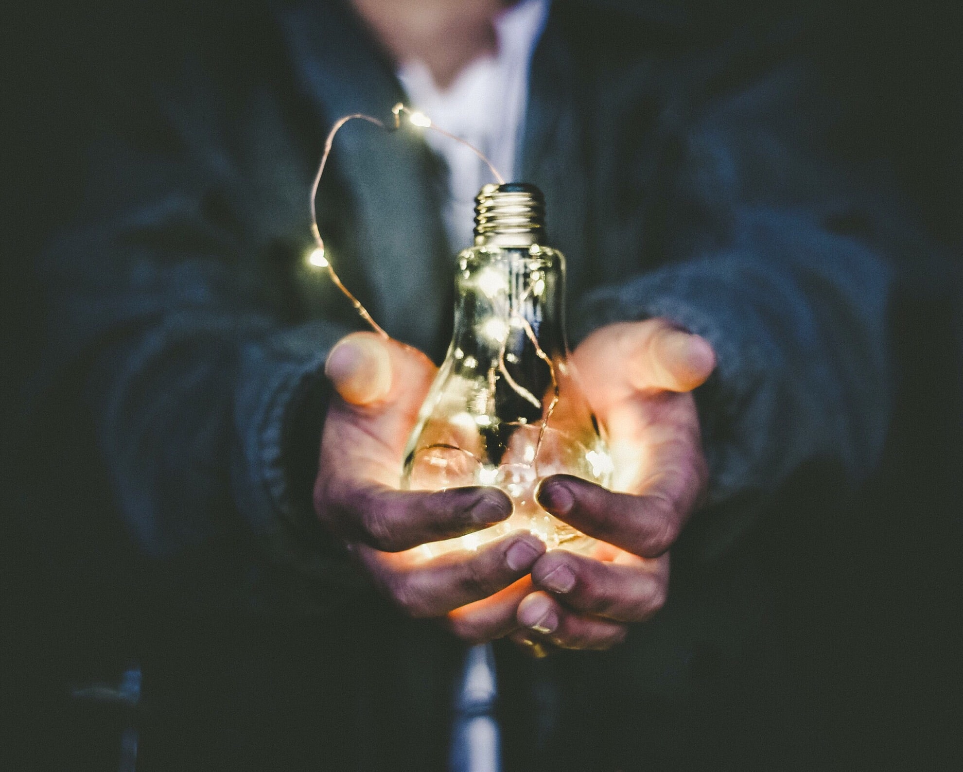 man holding a light bulb