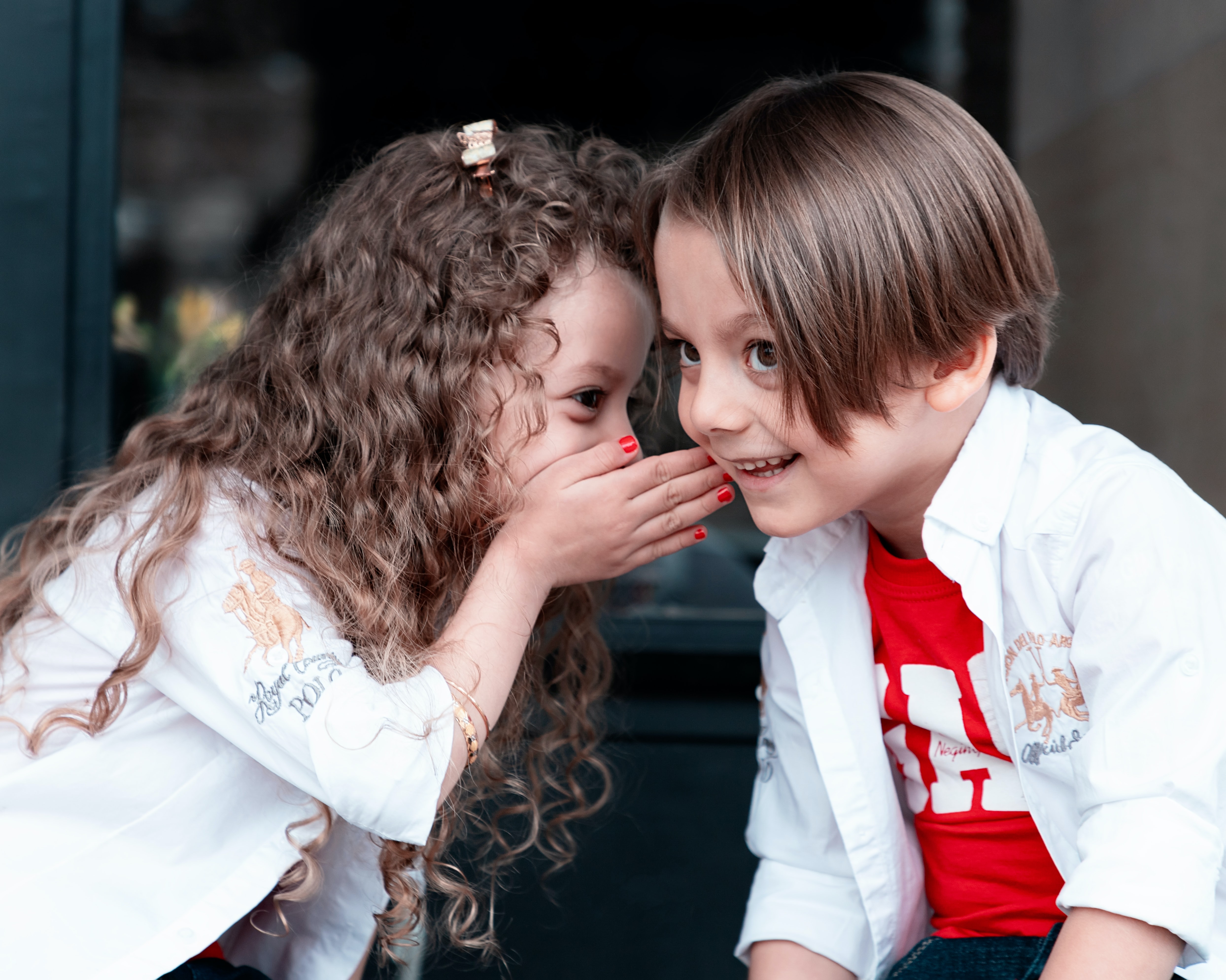Two children whispering together