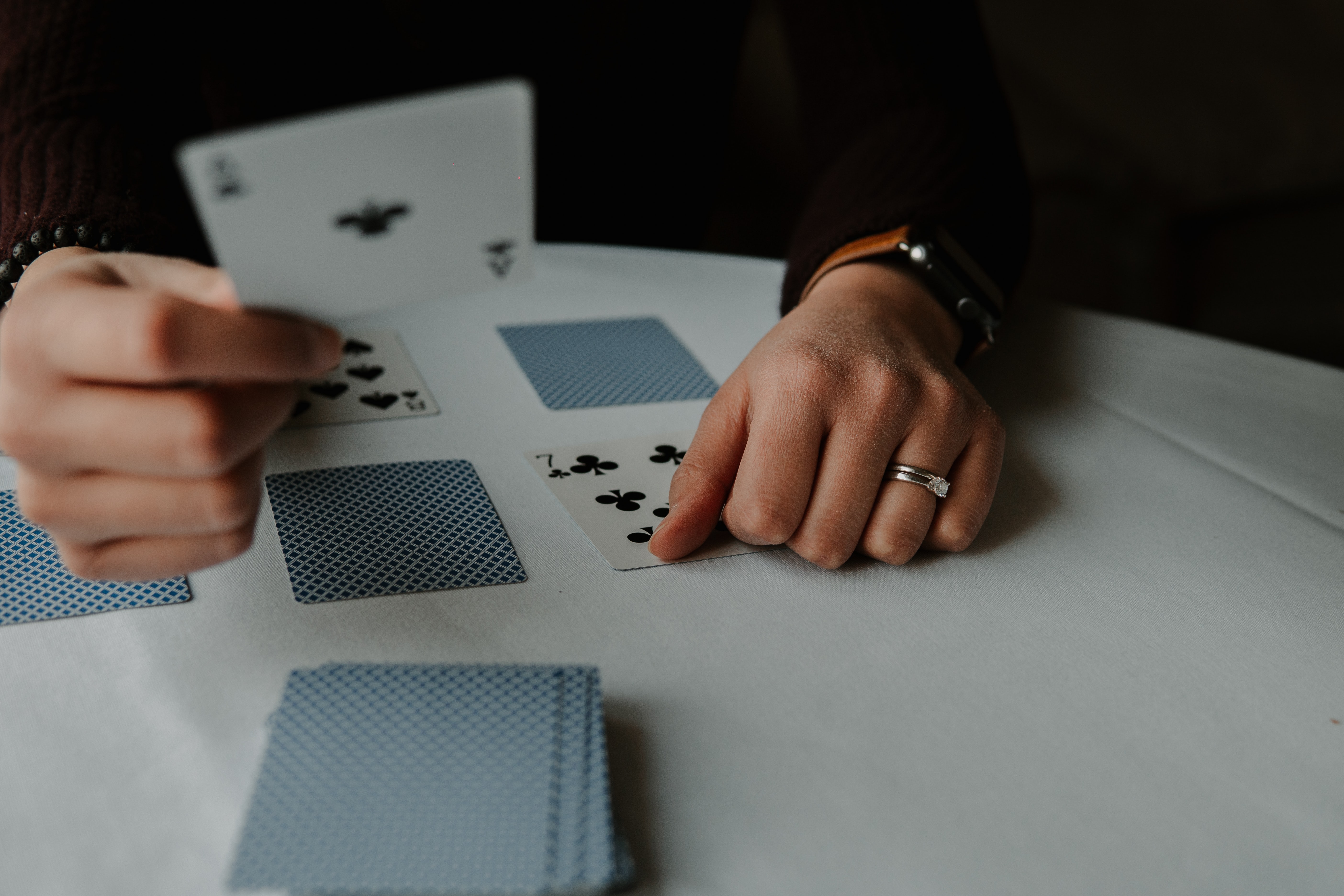 A person using playing cards on a table