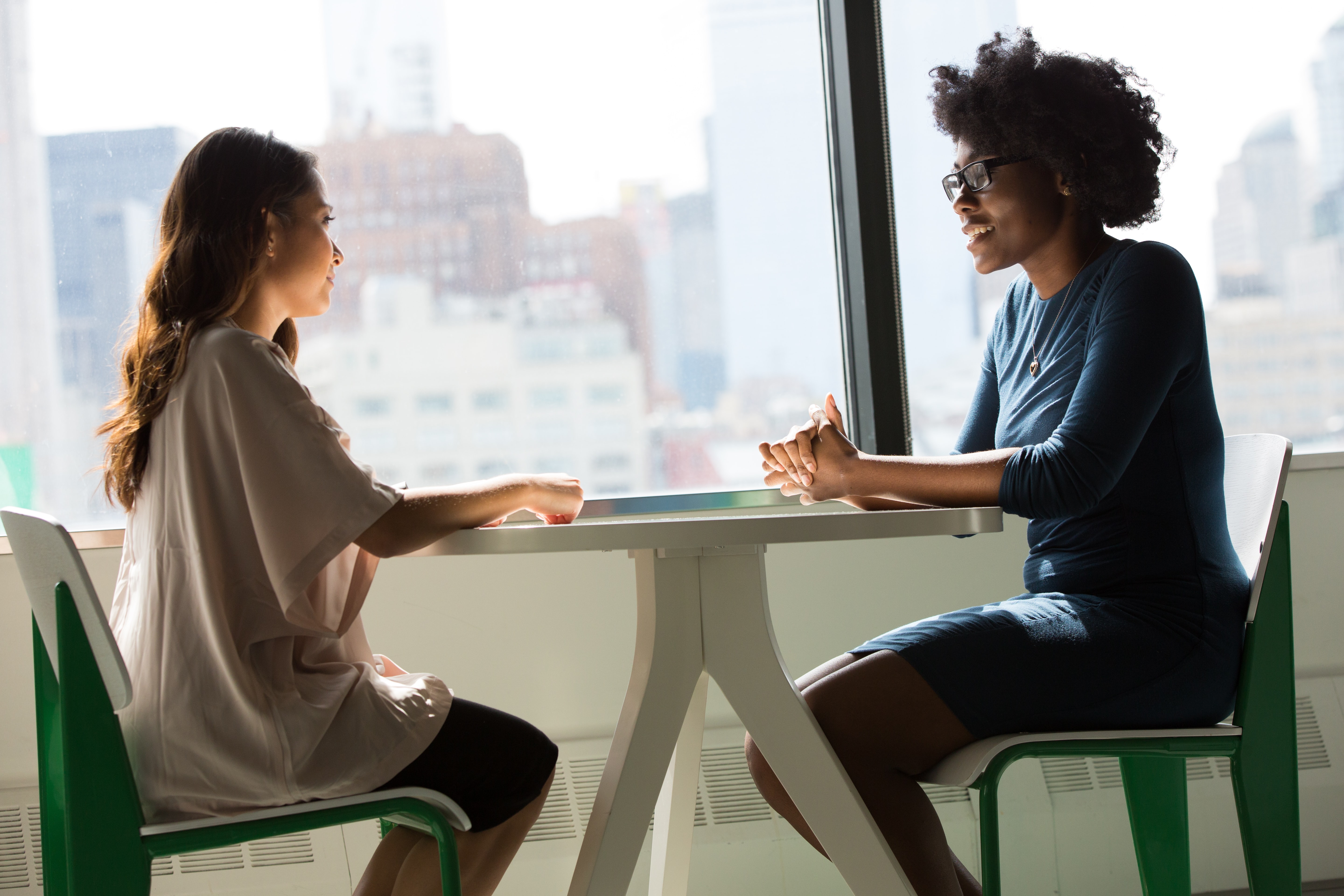 Two women sitting at a table doing a job interview