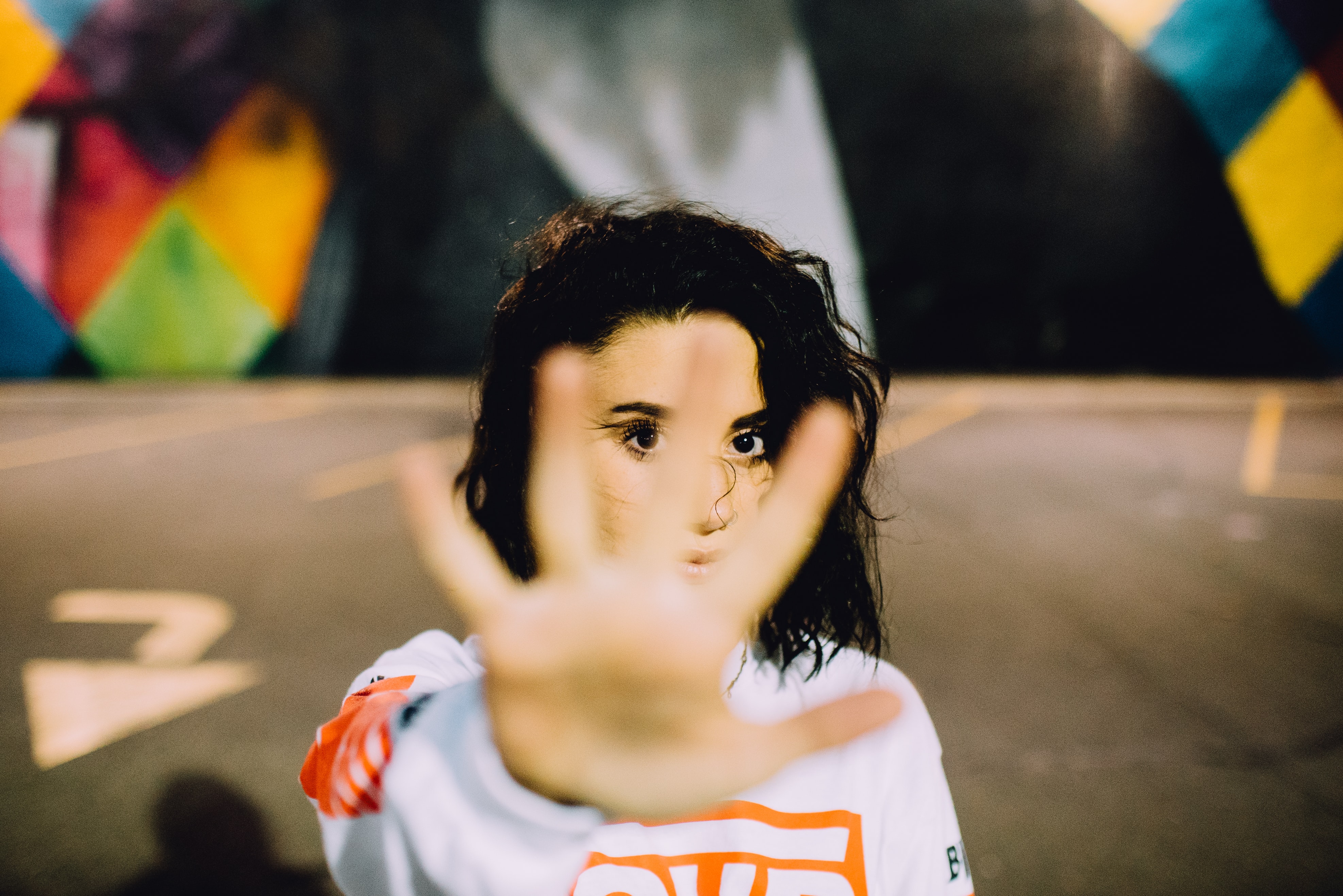 woman holding her hand out in stop gesture