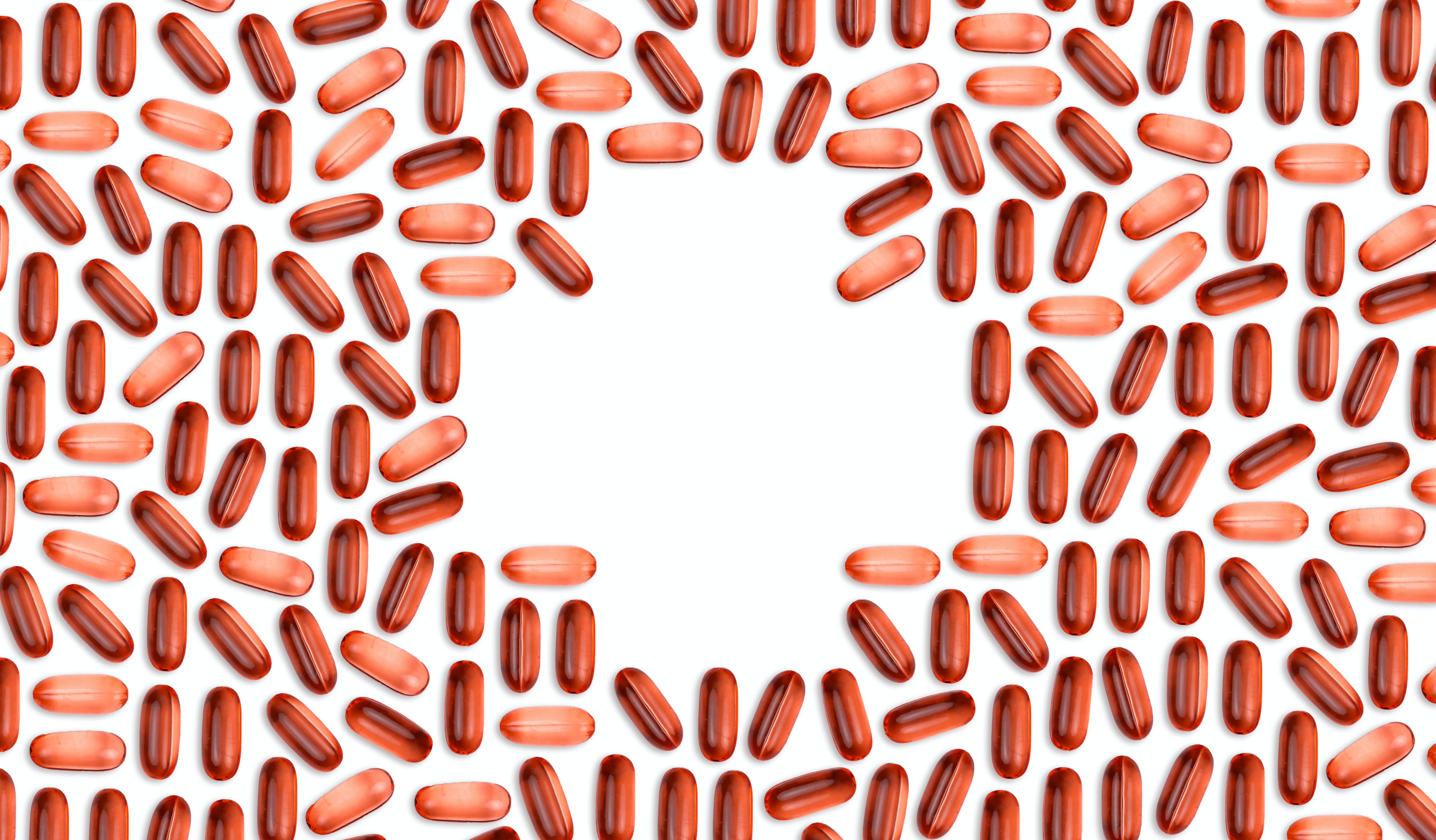 Red tablets placed in pattern to form a cross on a white background