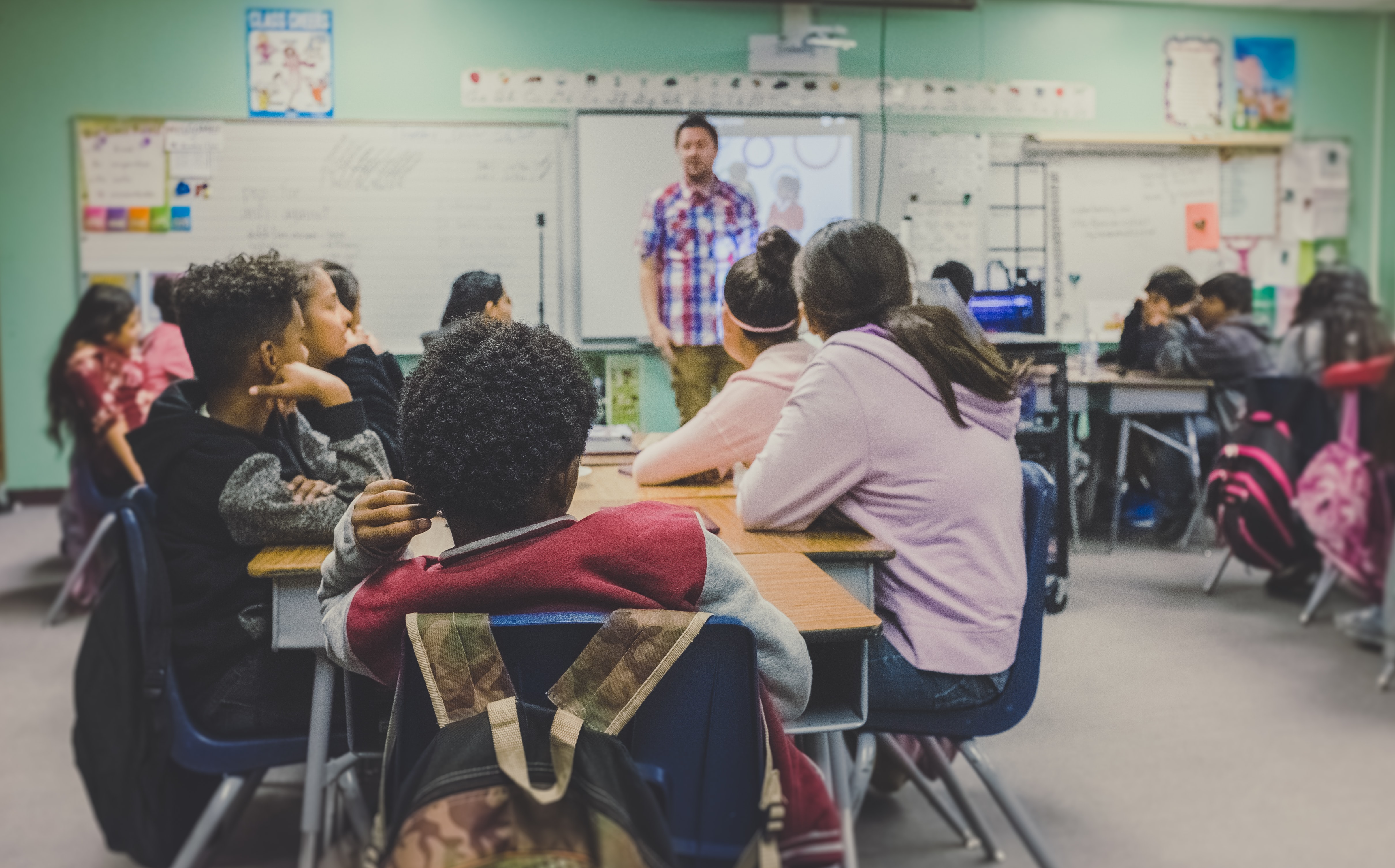 Students listening to a teacher in a classroom
