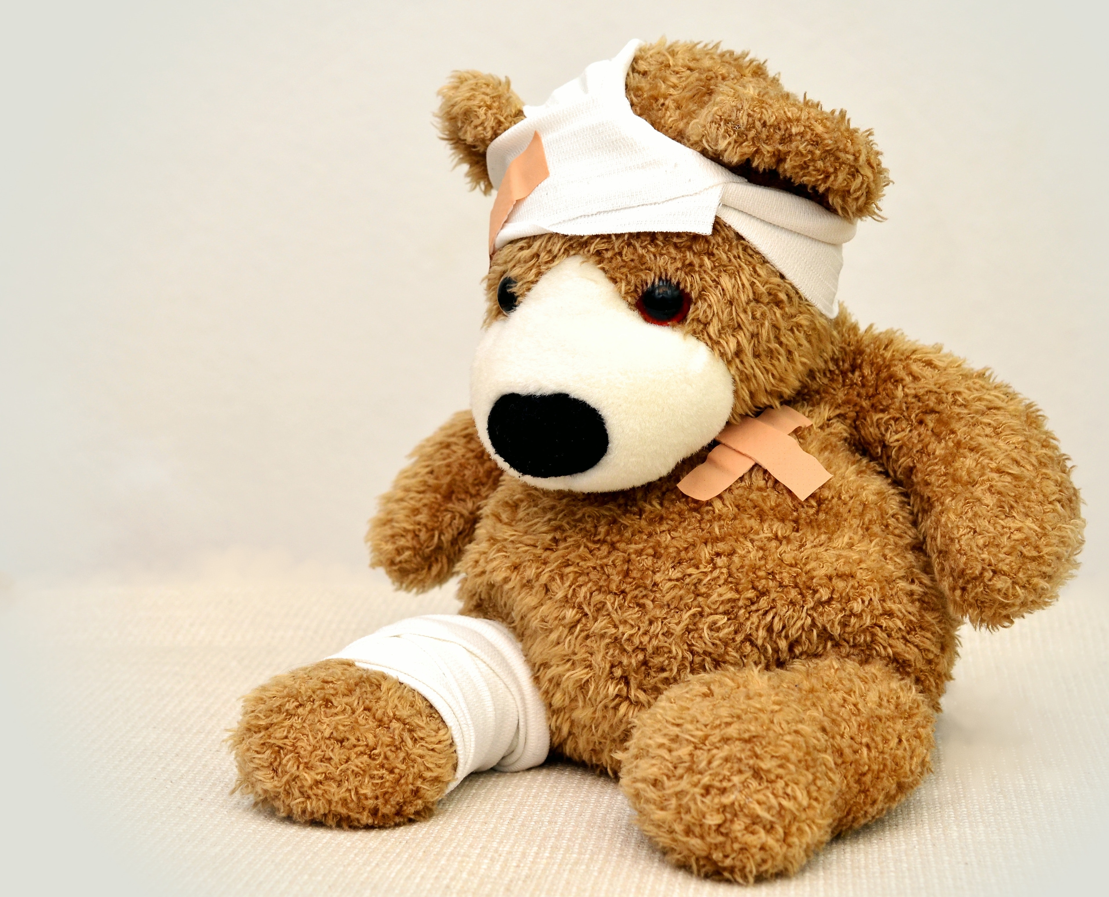 A teddy bear wearing a bandage