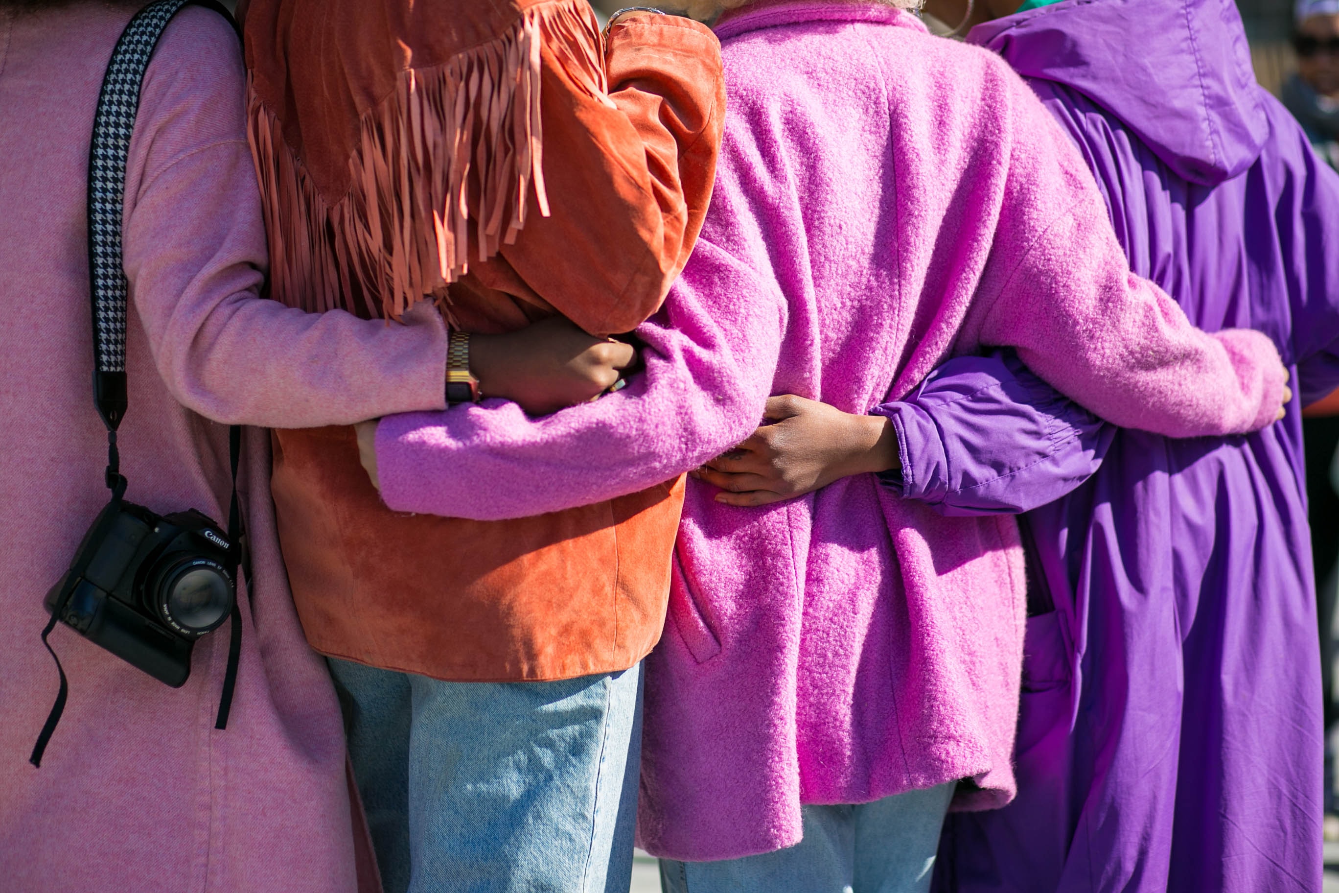 A shot taken from behind a group of people standing together for a photo. 